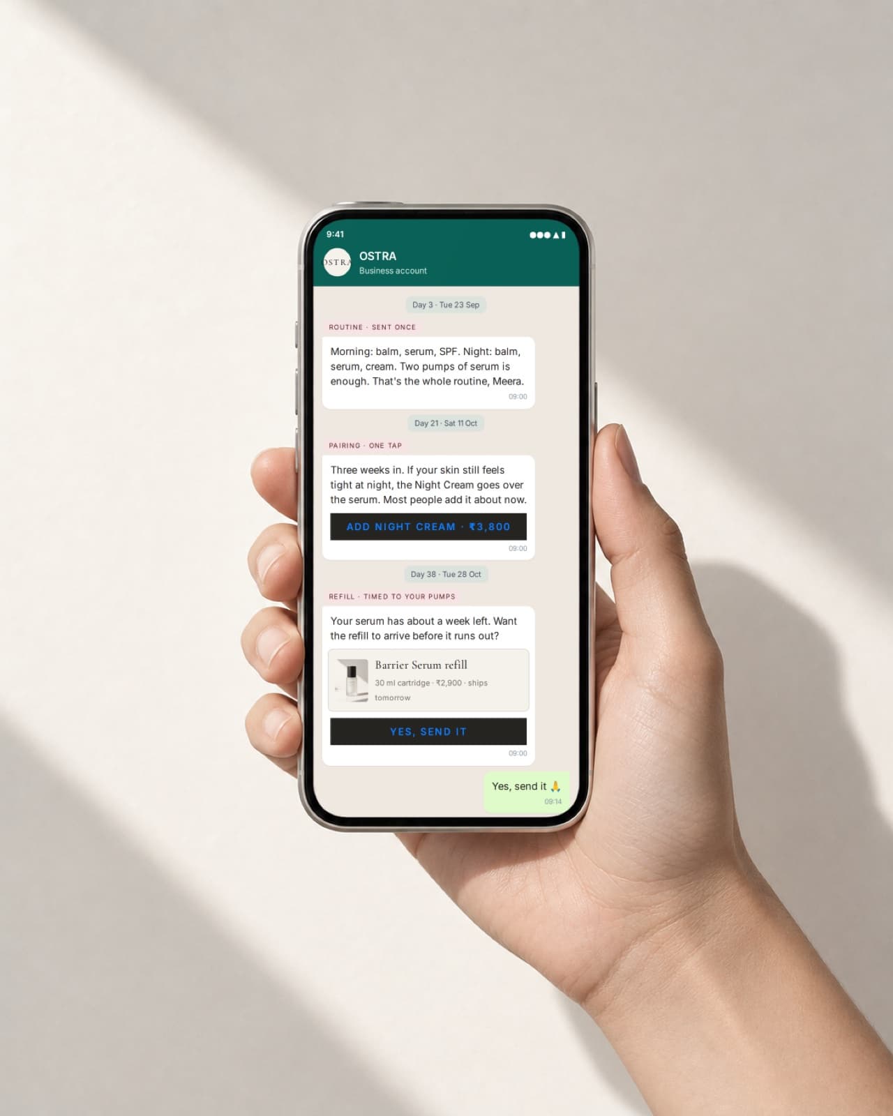 A hand holding a phone showing a WhatsApp refill conversation concept for OSTRA