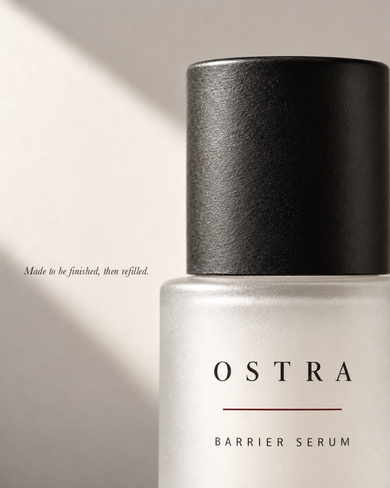 Close-up of the OSTRA serum bottle cap and wordmark